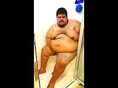 Superchub Squeezing himself in a tiny walk in shower with a built in seat